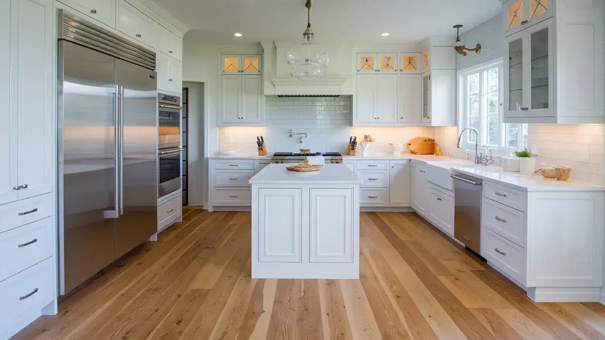 California kitchen with durable WPC flooring, professionally installed by California flooring companies, complemented by white cabinets and stainless steel appliances
